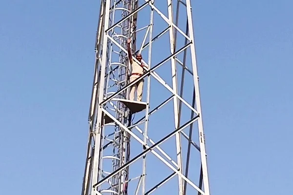 Police Constable on Mobile Phone tower