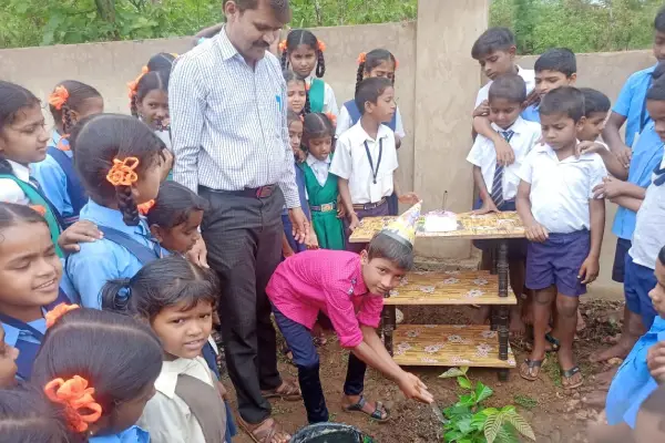Govt School Children Celebrating birthday in front of Plant.