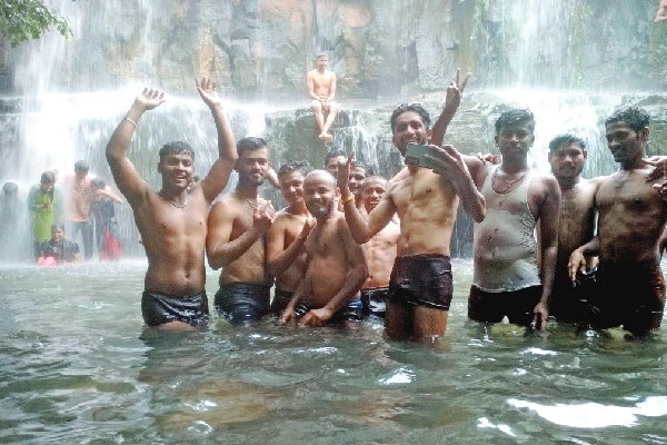 Tourists celebrate at Guledagudda waterfall