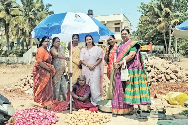 Distribution of umbrellas to women traders